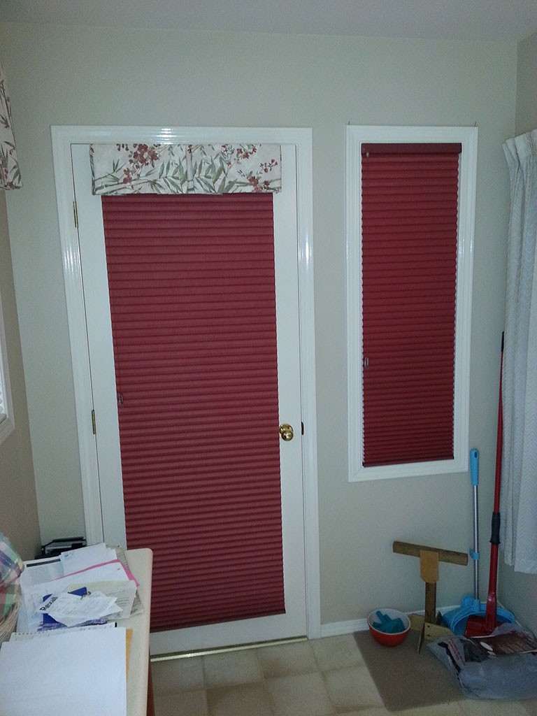 matching soft red shades completely blocking the light from a glass door and adjacent window