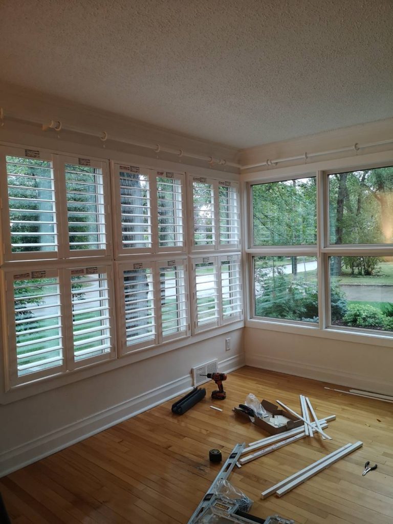 a room with a lot of windows and tools on the floor